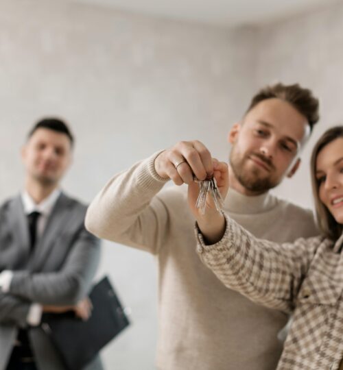 Couple receiving keys to their new home
