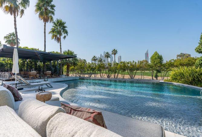 Pool with Dubai Marina skyline and golf course views